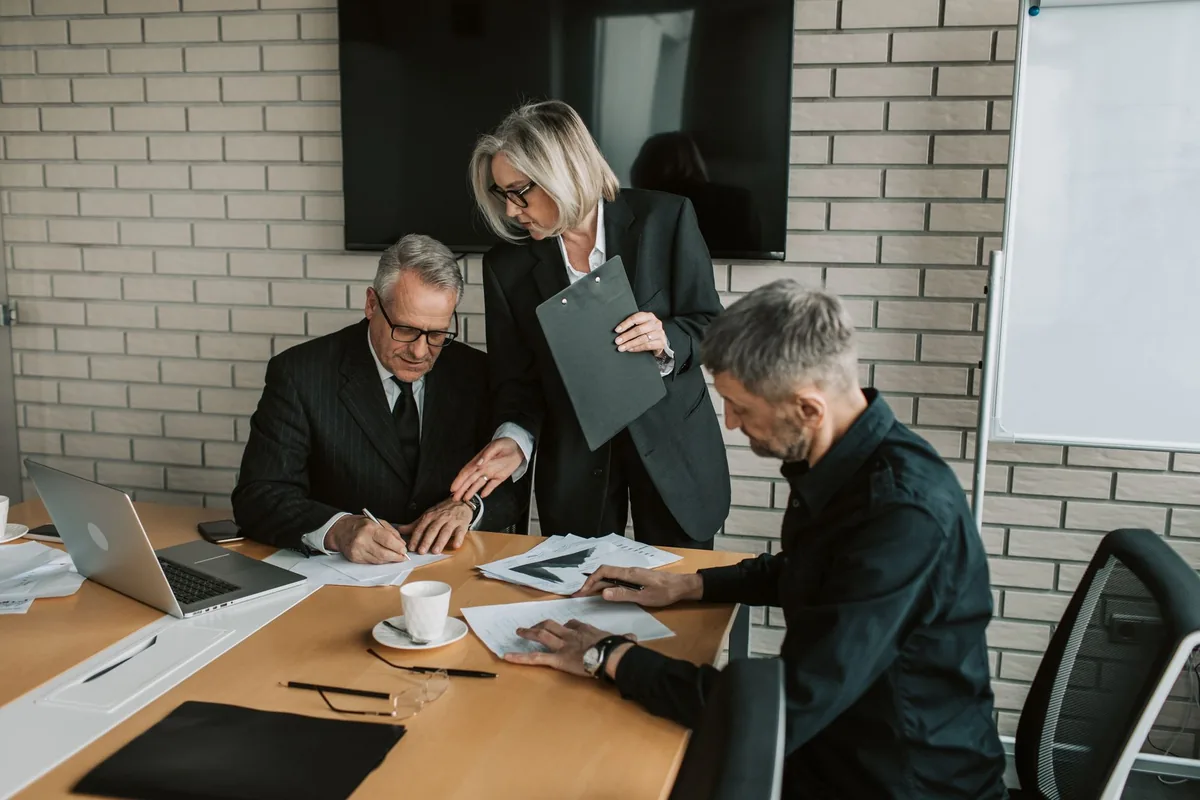 A business coach and an executive coach meeting, showing the difference